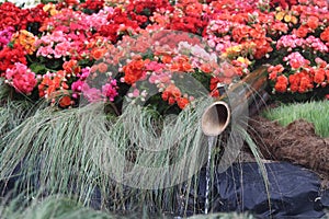 The bamboo cylinder flowing water to the pond, decorate for garden