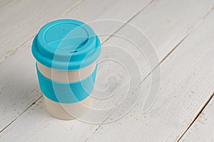 Bamboo eco cup for take away on white wooden background. Zero waste concept, no plastic