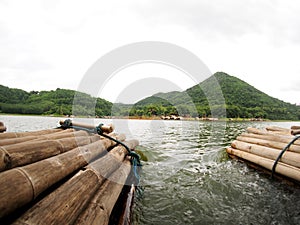 Bamboo floating raft in high mountain lake panorama view