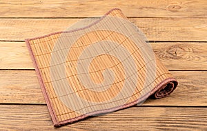 Bamboo food mat on a wooden background