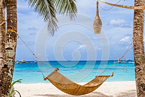 bamboo hammok on tropical beach and sea background, summer vacations