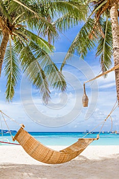 bamboo hammok on tropical beach and sea background, summer vacations