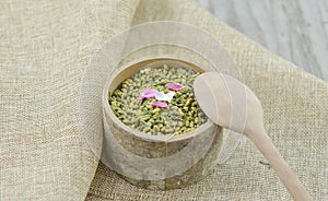 Bamboo jar with rice tea in wooden table