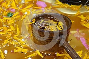 bamboo ladles and flower petals with water