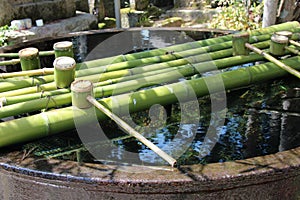 Bamboo ladles were installed for the ablutions in the courtyard of a shintoist temple in Amanohashidate (Japan)