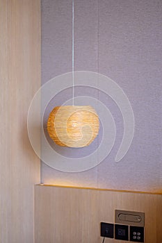 Bamboo lamp hanging in bedroom. Scandinavian, minimal and bohemian style
