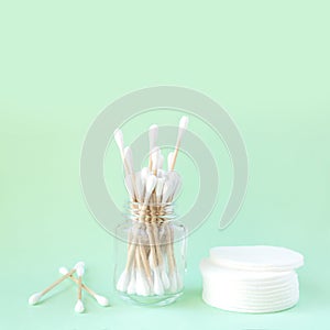 Bamboo organic cotton swabs in glass jar and cotton pads