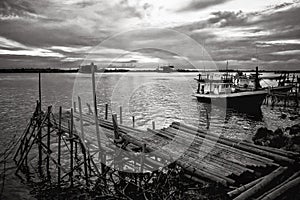 Bamboo pier and fishing boat