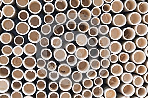 bamboo pile stacked vertically create texture wall background. Circle in front of pipes pattern