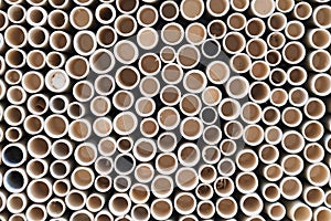 bamboo pile stacked vertically create texture wall background. Circle in front of pipes pattern