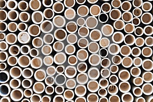bamboo pile stacked vertically create texture wall background. Circle in front of pipes pattern