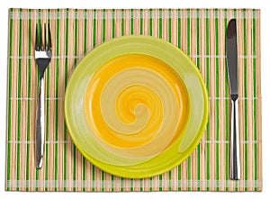 Bamboo placemat with plate fork, knife top view