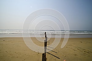 Bamboo poles bifurcating Chandrabhaga beach, Konark, India.