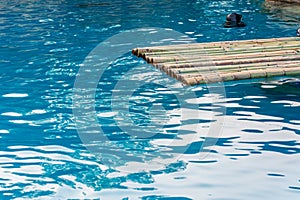 Bamboo raft on blue pool