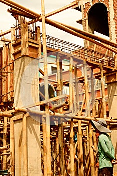 Construction site with bamboo scaffolding and.