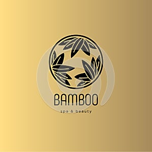 Bamboo spa salon logo. Spa emblem. Bamboo leaves in a circle with letters. Gold background.