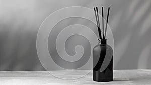 Bamboo sticks in a black bottle with indoor perfumes. Glass diffuser with fragrance. Copy space