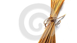 Bamboo sticks tied with rope on a white background.