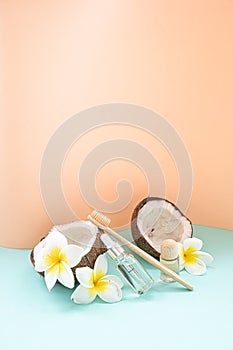 Bamboo toothbrush and bootle essential oil on a table with copy space on a white background. Styled composition of flat