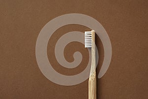 Bamboo toothbrush on brown background