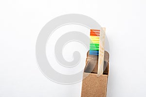 Bamboo toothbrush in a cardboard packaging with copy space on a white background