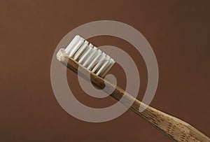 Bamboo toothbrush on carton background macro