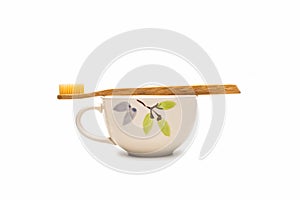 Bamboo toothbrush on ceramic mug