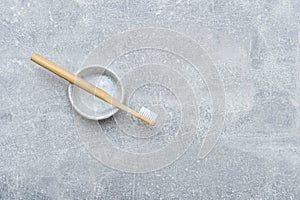 Bamboo toothbrush in holder on grey background. Zero waste concept