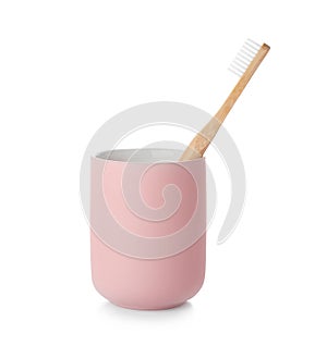 Bamboo toothbrush in holder on white background.