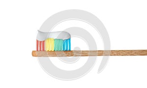 Bamboo toothbrush with paste on white background