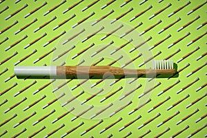 Bamboo toothbrush with a white handle on green toothbrushes pattern