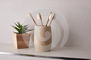 Bamboo toothbrushes in bathroom with copy space