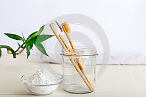 Bamboo toothbrushes, dentifrice tooth powder on white background. Natural bath products, bamboo plant.Biodegradable natural bamboo photo