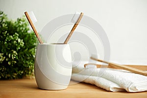 The bamboo toothbrushes in a gray glass with copy space photo