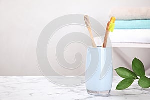 Bamboo toothbrushes on marble table