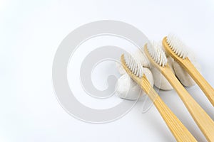 Bamboo toothbrushes on white stone