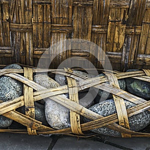 Bamboo weaved container full of pebbles called Longshi