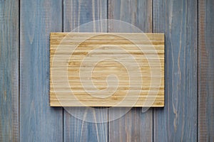 Bamboo wood cutting board on a wooden gray background
