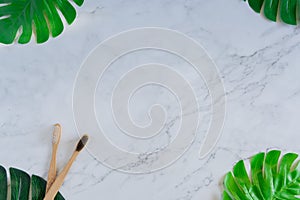 Bamboo wood toothbrush on clean white marble table top view background concept for save the earth day, world environmental,