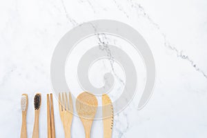 Bamboo wood toothbrush on clean white marble table top view background concept for save the earth day, world environmental,