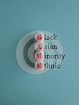 BAME symbol. Abbreviation BAME, black, asian and minority ethnic on wooden cubes. photo