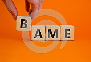 BAME symbol. Abbreviation BAME, black, asian and minority ethnic on wooden cubes. Beautiful orange background. Copy space. photo