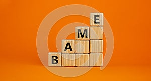 BAME symbol. Abbreviation BAME, black, asian and minority ethnic on wooden cubes. Beautiful orange background. Copy space. photo