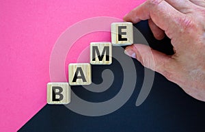 BAME symbol. Abbreviation BAME, black, asian and minority ethnic on wooden cubes. Beautiful purple and black background. Copy