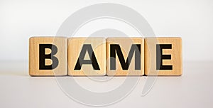 BAME symbol. Abbreviation BAME, black, asian and minority ethnic on wooden cubes. Beautiful white background. Copy space. Business