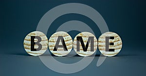 BAME symbol. Abbreviation BAME, black, asian and minority ethnic on wooden circles. Beautiful grey background. Copy space. photo