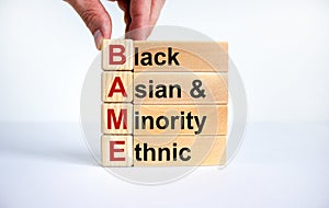 BAME symbol. Abbreviation BAME, black, asian and minority ethnic on wooden cubes. Beautiful white background. Copy space. Business photo