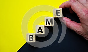 BAME symbol. Abbreviation BAME, black, asian and minority ethnic on wooden cubes. Beautiful yellow and black background. Copy photo