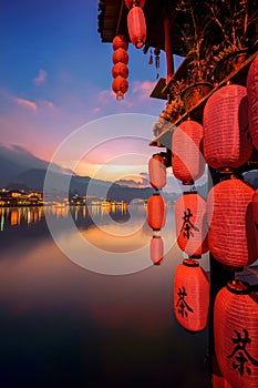 Ban Rak Thai Village in mist on the lake, Mae Hong Son province in Thailand. Chinese characters on red lantern means tea -