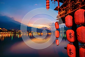 Ban Rak Thai Village in mist on the lake, Mae Hong Son province in Thailand. Chinese characters on red lantern means tea -